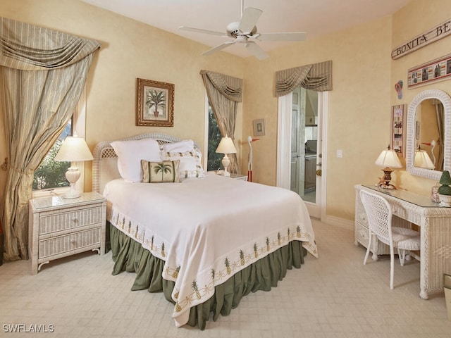 carpeted bedroom with ceiling fan, access to outside, and baseboards