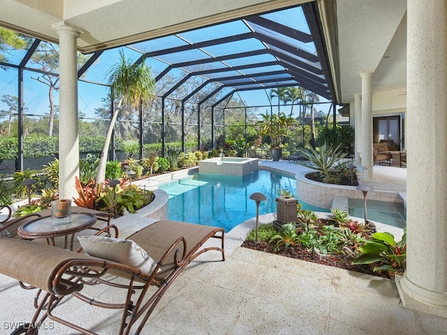 view of pool with a lanai, a patio area, and a pool with connected hot tub