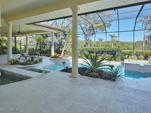 pool with a ceiling fan, a lanai, a patio, and an in ground hot tub