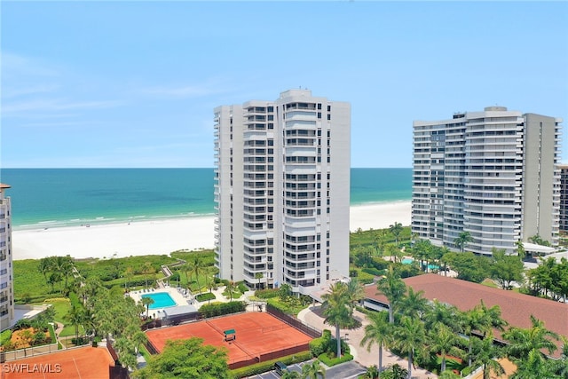 birds eye view of property with a water view and a beach view