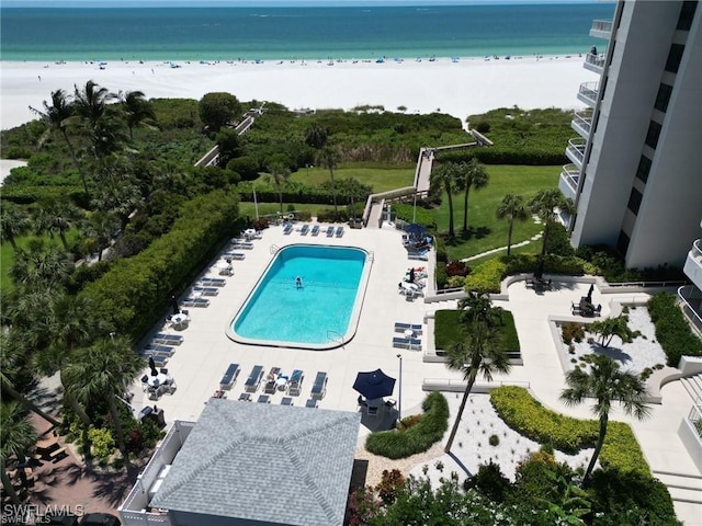 birds eye view of property with a view of the beach and a water view