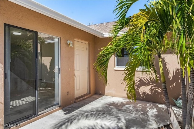 doorway to property with a patio