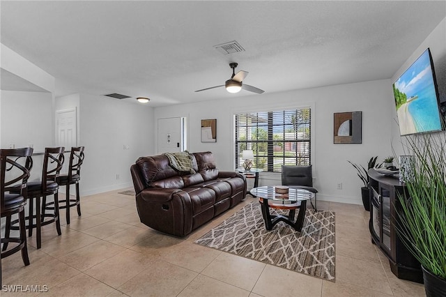 tiled living room with ceiling fan