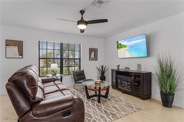 tiled living room featuring ceiling fan