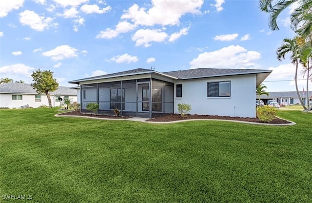 view of front of house with a sunroom and a front lawn