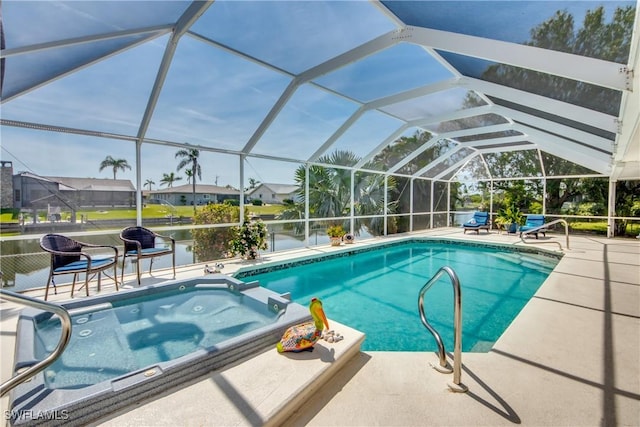 view of pool featuring a lanai, a patio area, and an in ground hot tub