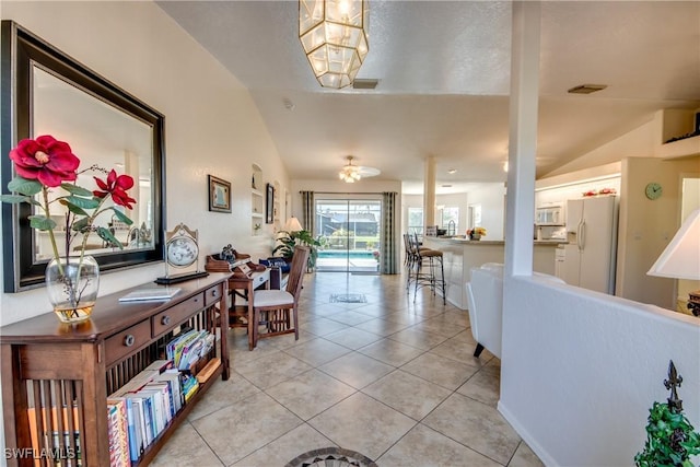 tiled foyer entrance featuring vaulted ceiling and ceiling fan