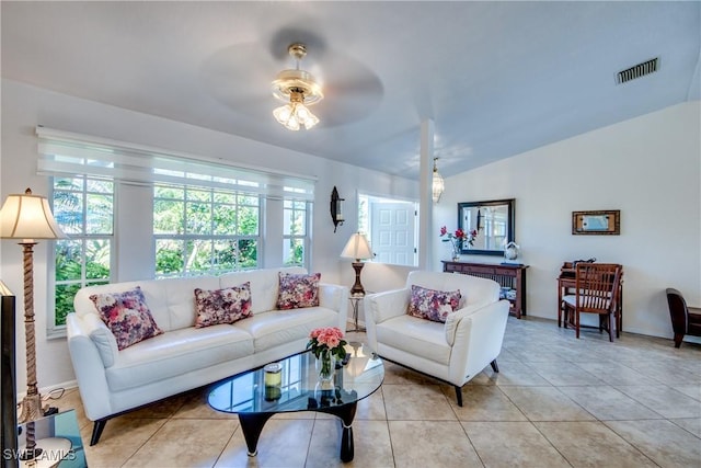 tiled living room featuring ceiling fan and lofted ceiling