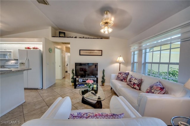 living room with ceiling fan, light tile patterned floors, and lofted ceiling