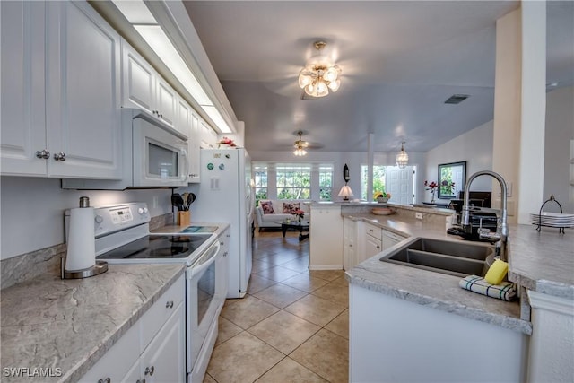 kitchen with sink, kitchen peninsula, lofted ceiling, white appliances, and white cabinets