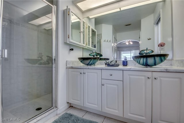 bathroom featuring tile patterned flooring, vanity, and an enclosed shower