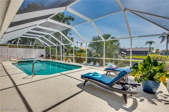 view of swimming pool with glass enclosure and a patio area