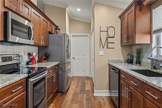 kitchen with light stone countertops, dark hardwood / wood-style flooring, stainless steel appliances, crown molding, and sink