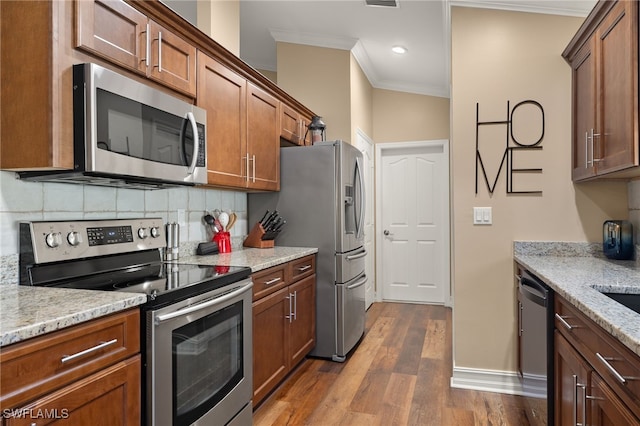 kitchen featuring backsplash, dark wood-type flooring, crown molding, light stone countertops, and appliances with stainless steel finishes