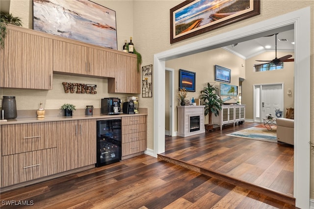 bar featuring light brown cabinetry, ornamental molding, ceiling fan, dark wood-type flooring, and wine cooler