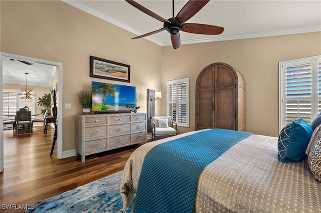 bedroom with ceiling fan with notable chandelier, dark hardwood / wood-style flooring, and crown molding