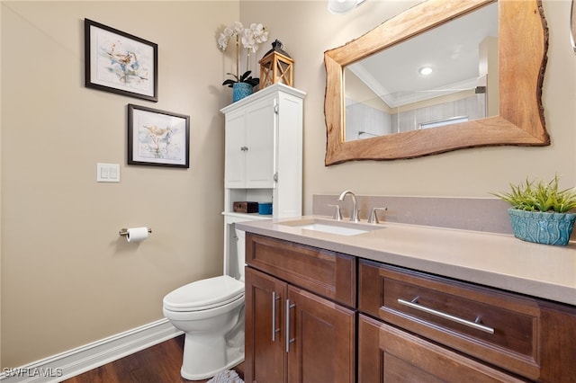 bathroom featuring crown molding, toilet, vanity, and hardwood / wood-style flooring