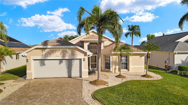 view of front of home with a garage and a front yard