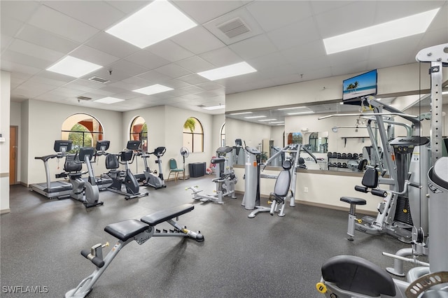 gym with a paneled ceiling