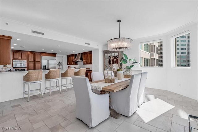 dining space featuring an inviting chandelier and ornamental molding