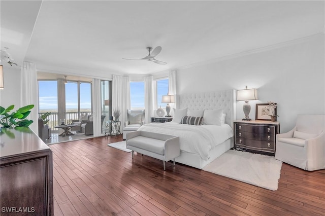 bedroom featuring access to exterior, dark hardwood / wood-style flooring, multiple windows, and ceiling fan