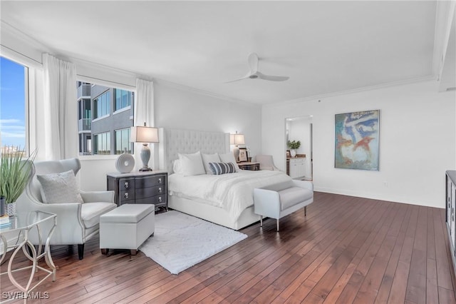 bedroom featuring dark hardwood / wood-style flooring, ceiling fan, and crown molding