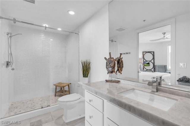 bathroom with ceiling fan, toilet, vanity, and walk in shower