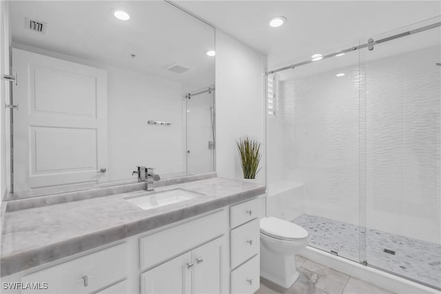 bathroom featuring vanity, toilet, and an enclosed shower