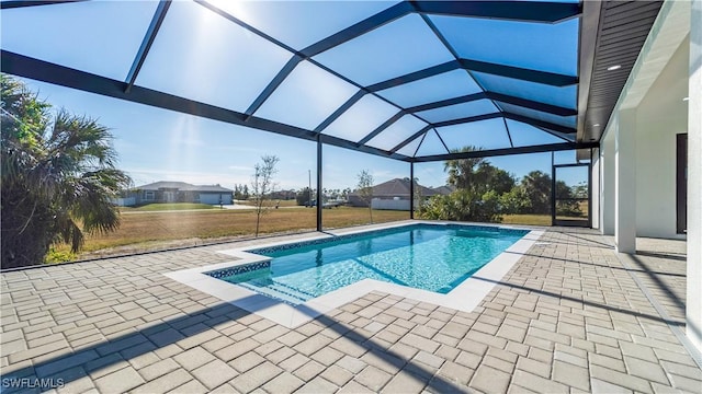 view of pool with a patio and glass enclosure