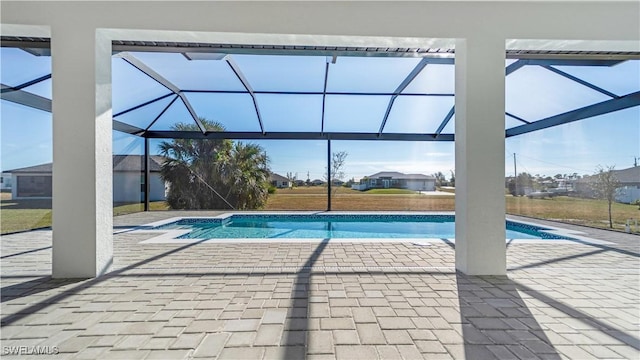 view of swimming pool featuring a lanai and a patio area