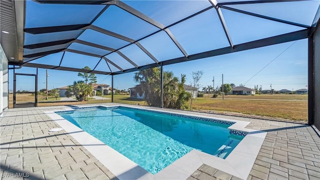 view of pool featuring glass enclosure and a patio area