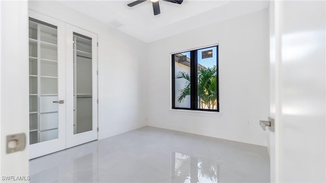 empty room with ceiling fan and french doors