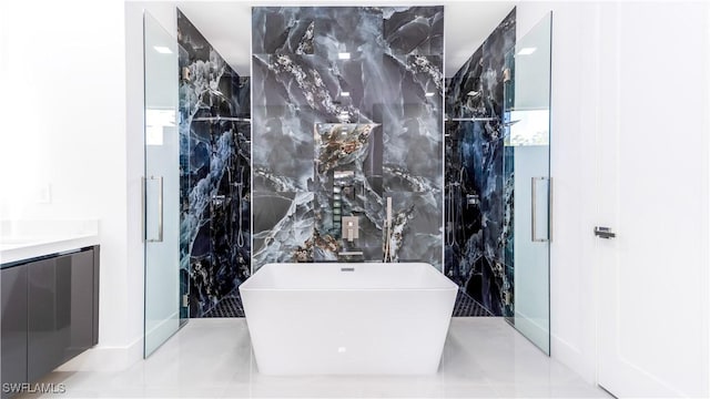 bathroom with a bathing tub, vanity, and tile walls