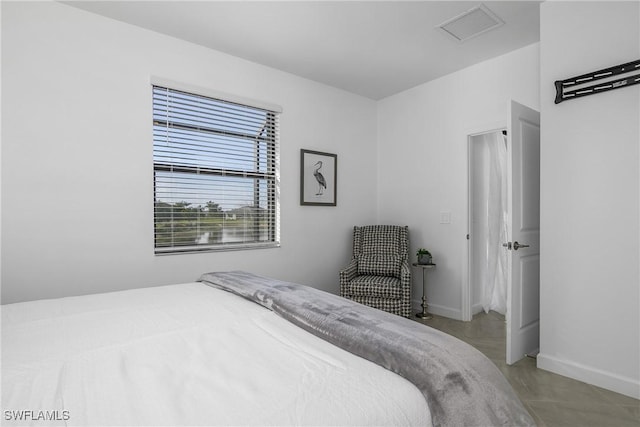 bedroom featuring visible vents and baseboards