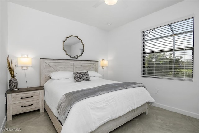 bedroom with baseboards and light tile patterned floors