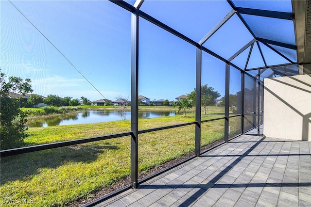 unfurnished sunroom featuring a healthy amount of sunlight and a water view