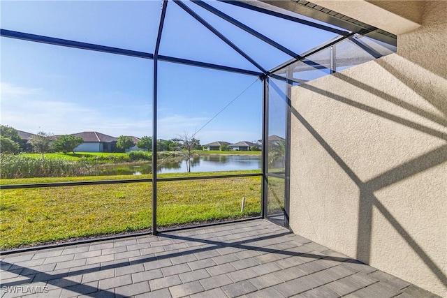 unfurnished sunroom featuring a water view