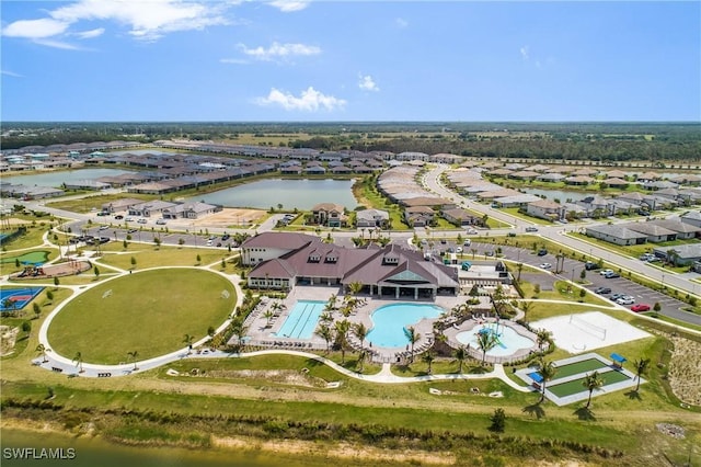 birds eye view of property with a water view and a residential view