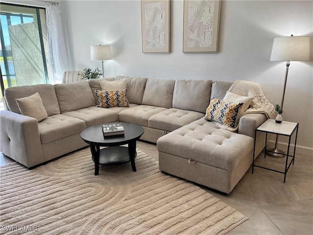 living area with light tile patterned floors and baseboards