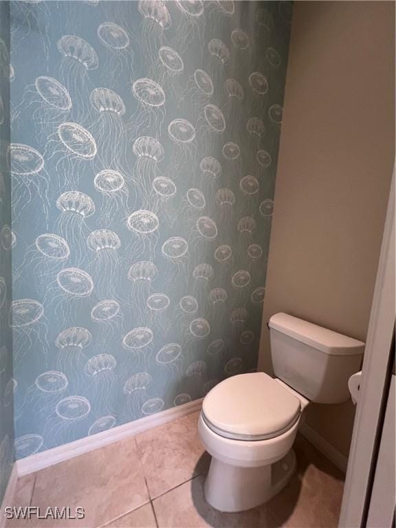 bathroom featuring tile patterned flooring and toilet