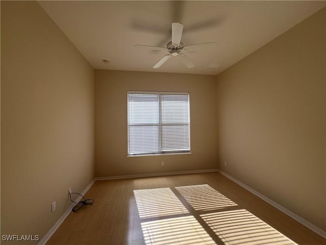 spare room featuring hardwood / wood-style floors and ceiling fan