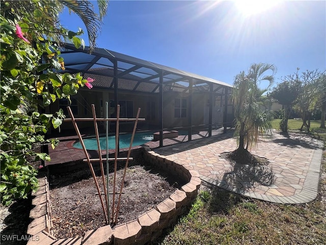 view of yard with a patio and glass enclosure