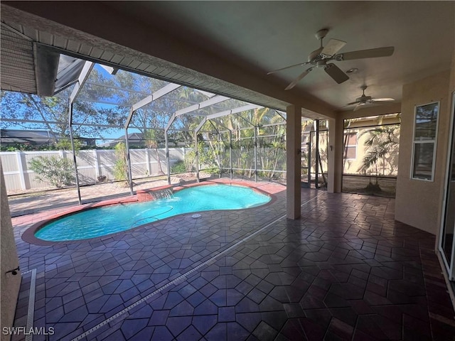 view of pool featuring a lanai, a patio area, ceiling fan, and pool water feature