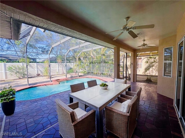 view of swimming pool featuring a patio, a lanai, and ceiling fan