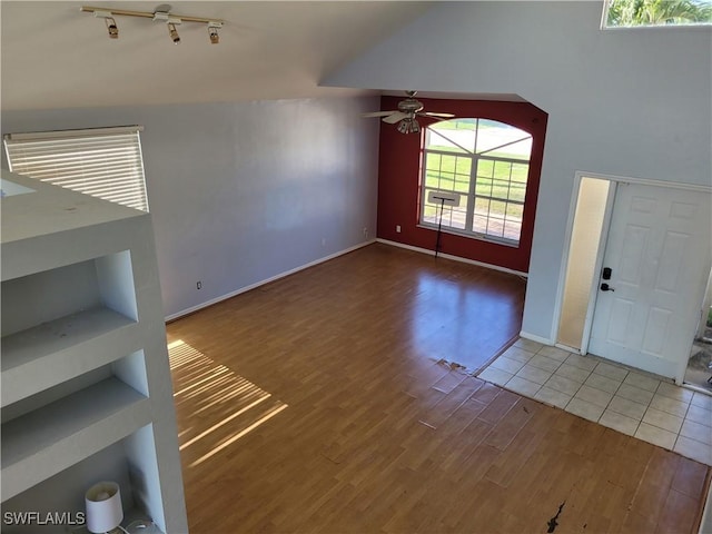 unfurnished living room featuring ceiling fan and hardwood / wood-style flooring