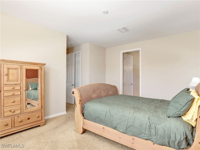 bedroom featuring light carpet