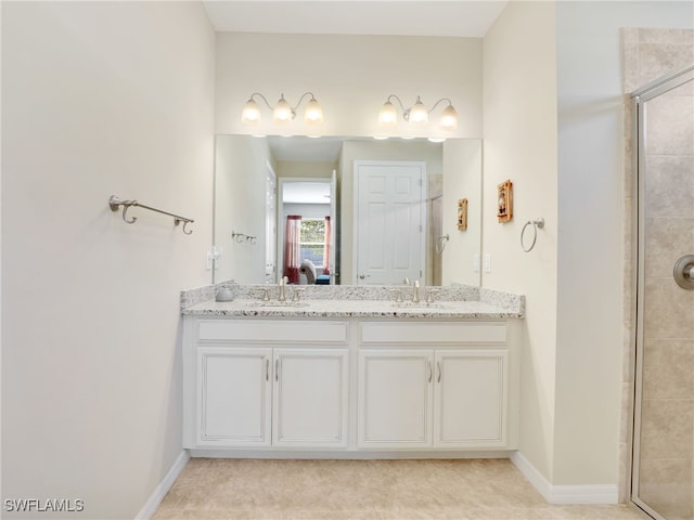 bathroom featuring tile patterned flooring, vanity, and walk in shower