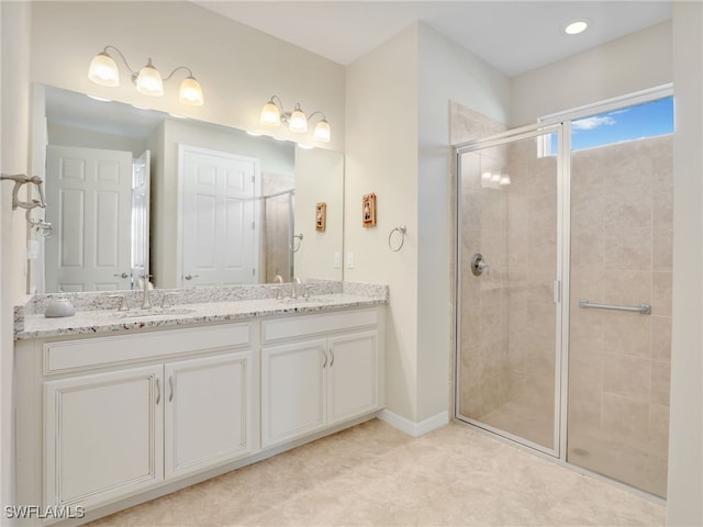 bathroom featuring vanity and a shower with door