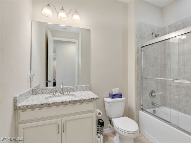 full bathroom featuring shower / bath combination with glass door, tile patterned flooring, vanity, and toilet