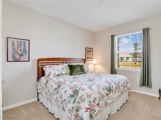 bedroom featuring light colored carpet